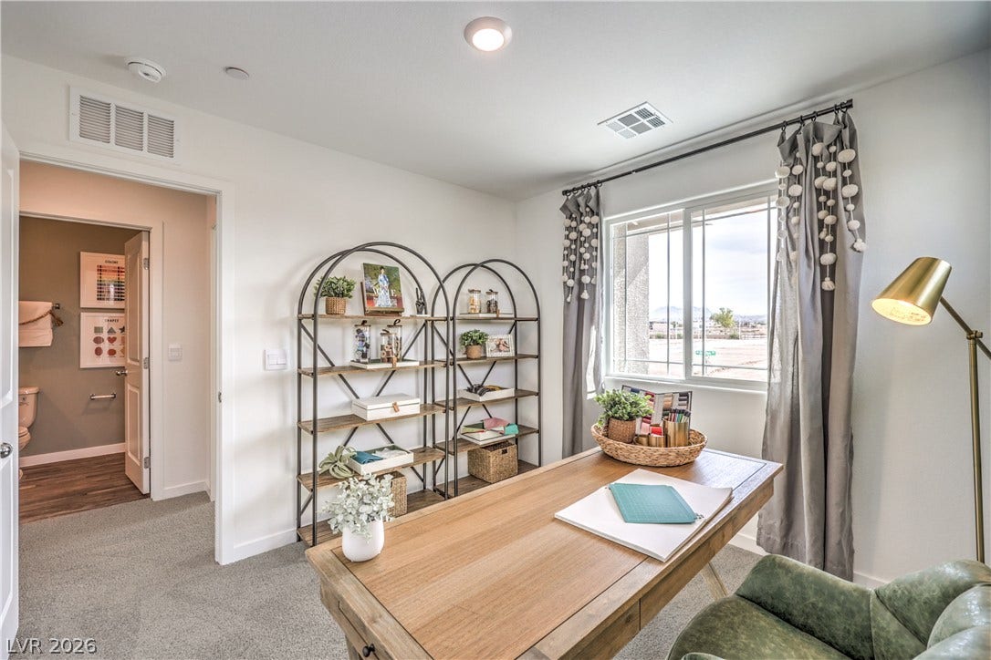 923 Black Heron Street, Henderson, NV 89011 A light-filled workspace features clean lines, soft carpeting, and a window overlooking neighborhood views.