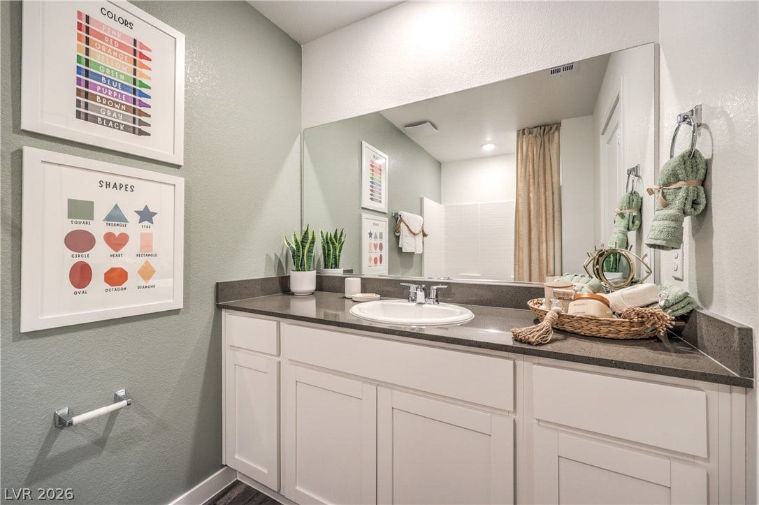 923 Black Heron Street, Henderson, NV 89011 Clean lines and stone counters highlight this well-appointed vanity area.