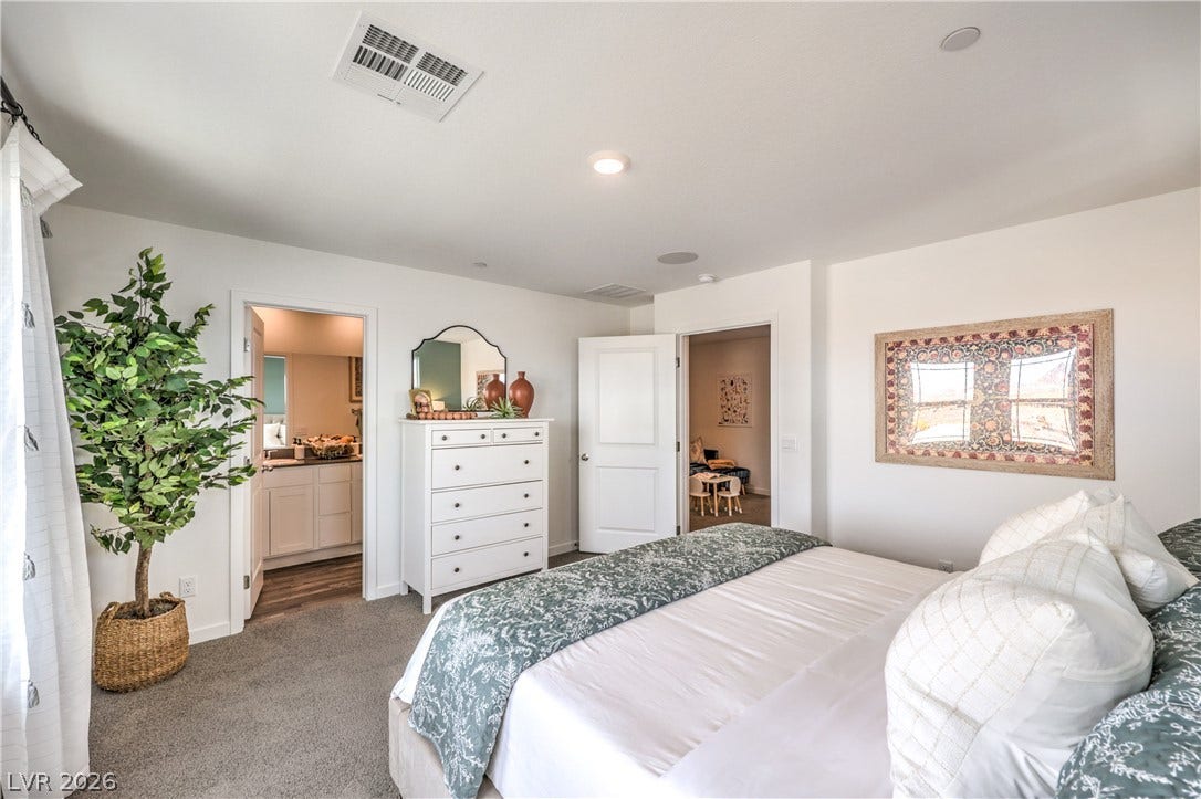 923 Black Heron Street, Henderson, NV 89011 Plush carpeting anchors this spacious bedroom featuring clean lines and recessed lighting.
