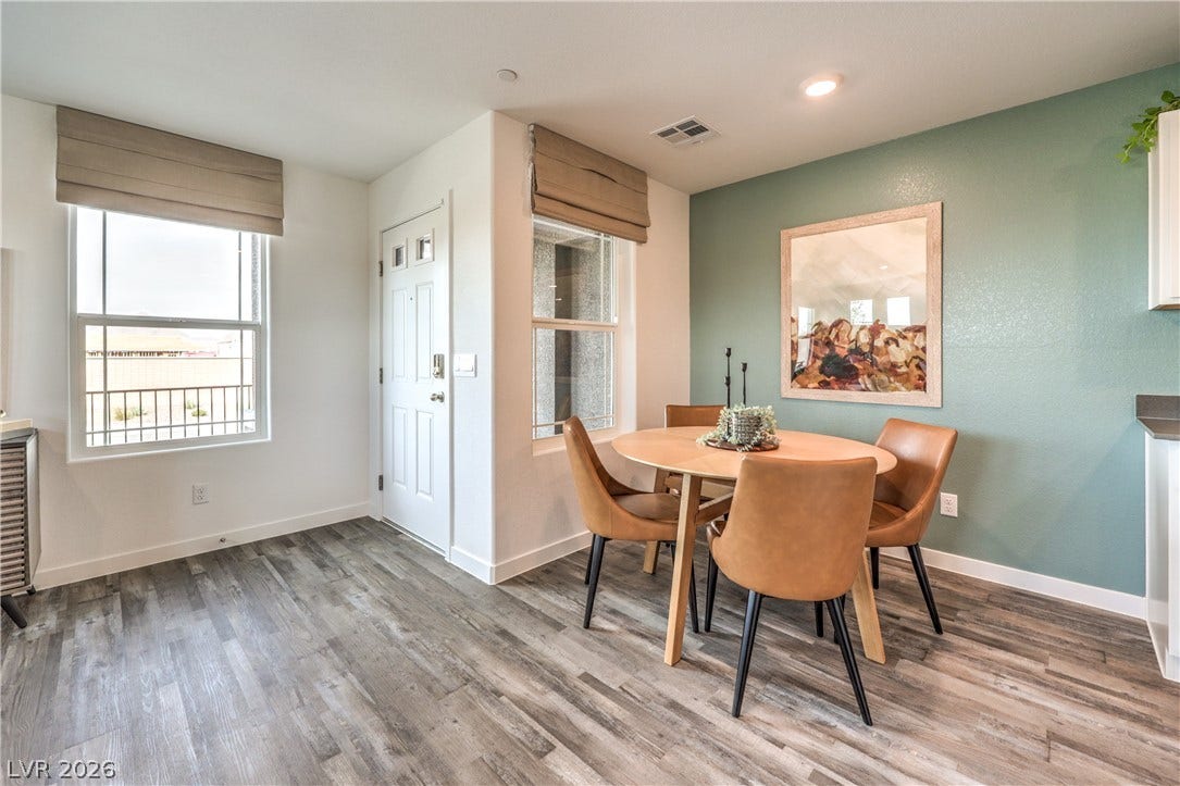 923 Black Heron Street, Henderson, NV 89011 Wide-plank wood-style flooring and recessed lighting define this versatile dining area near the entry.