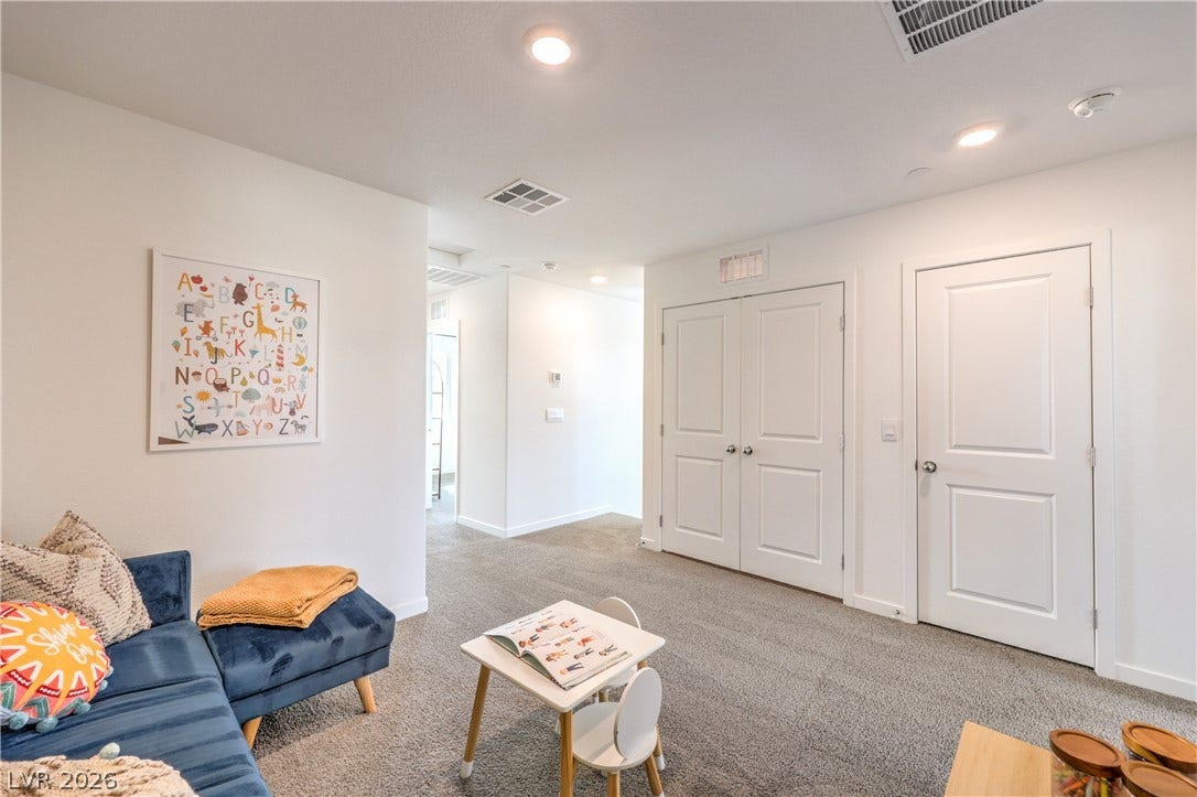 923 Black Heron Street, Henderson, NV 89011 Recessed lighting illuminates this versatile bonus space finished with soft carpeting and classic paneled doors.