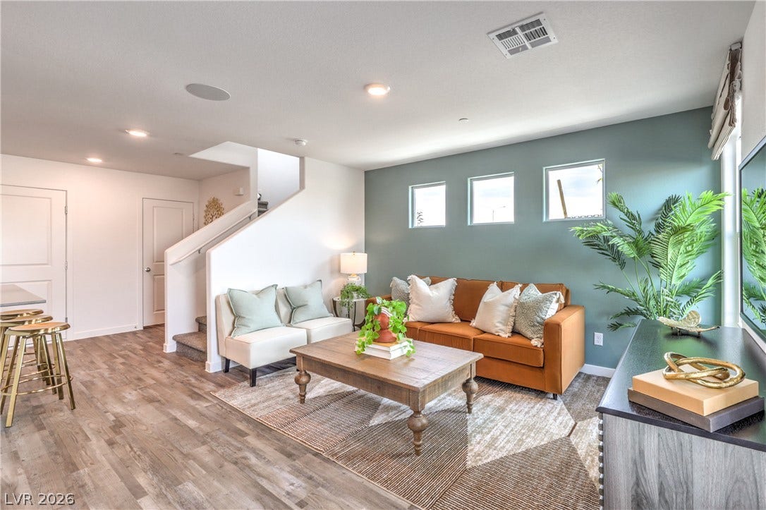 923 Black Heron Street, Henderson, NV 89011 An inviting open floorplan centers around a comfortable living area with warm wood flooring.