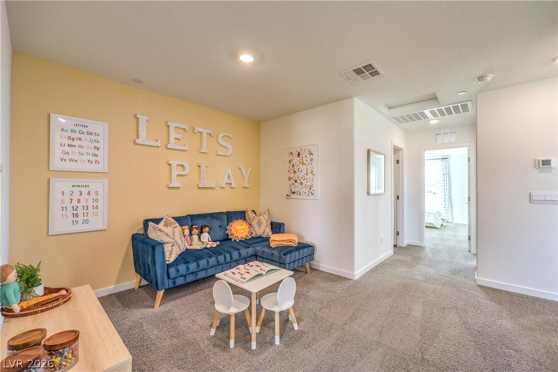 923 Black Heron Street, Henderson, NV 89011 A spacious upstairs loft features soft wall-to-wall carpeting and recessed lighting.