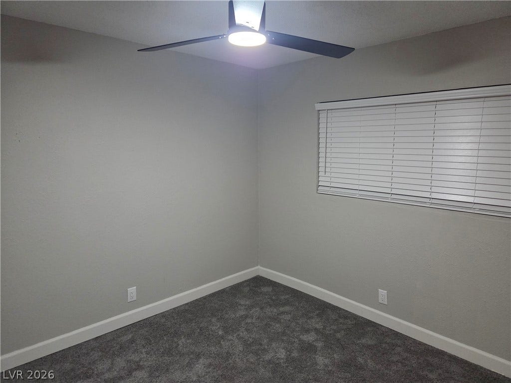 4364 Calimesa Street, Las Vegas, NV 89115 Plush carpeted flooring and neutral walls define this versatile bedroom space.