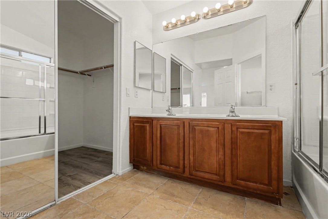 A spacious double vanity and tile flooring highlight this classic bathroom design.