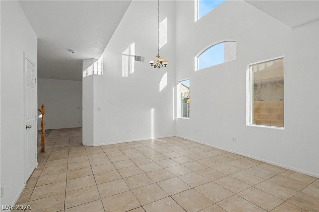 Soaring vaulted ceilings and durable tile flooring define this airy architectural layout.