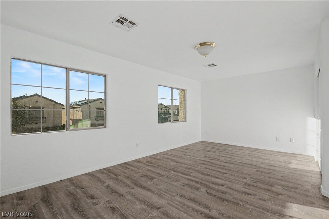 Clean lines and durable wood-look flooring define this versatile, light-filled interior space.
