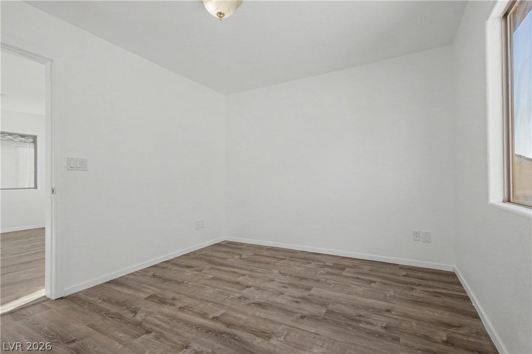 Crisp walls and modern plank flooring define this versatile, light-filled interior space.