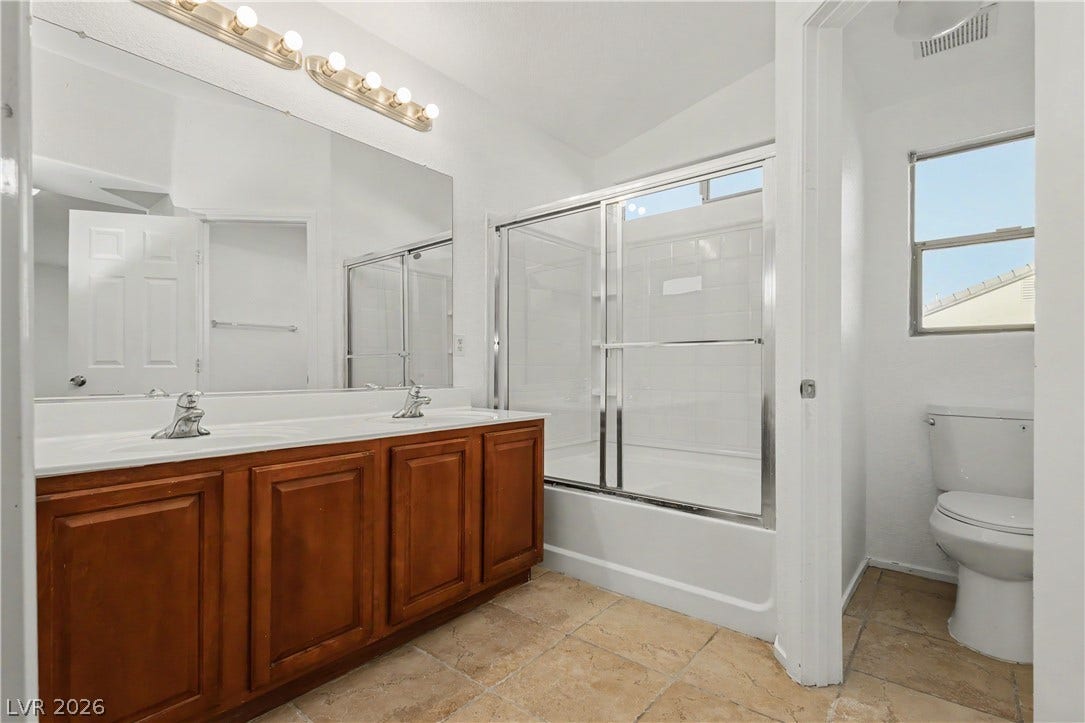 Double vanities and classic tile flooring define this functional bathroom layout.