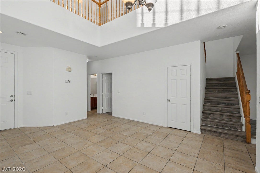 Gleaming tile floors and soaring high ceilings welcome visitors into this impressive entry hall.