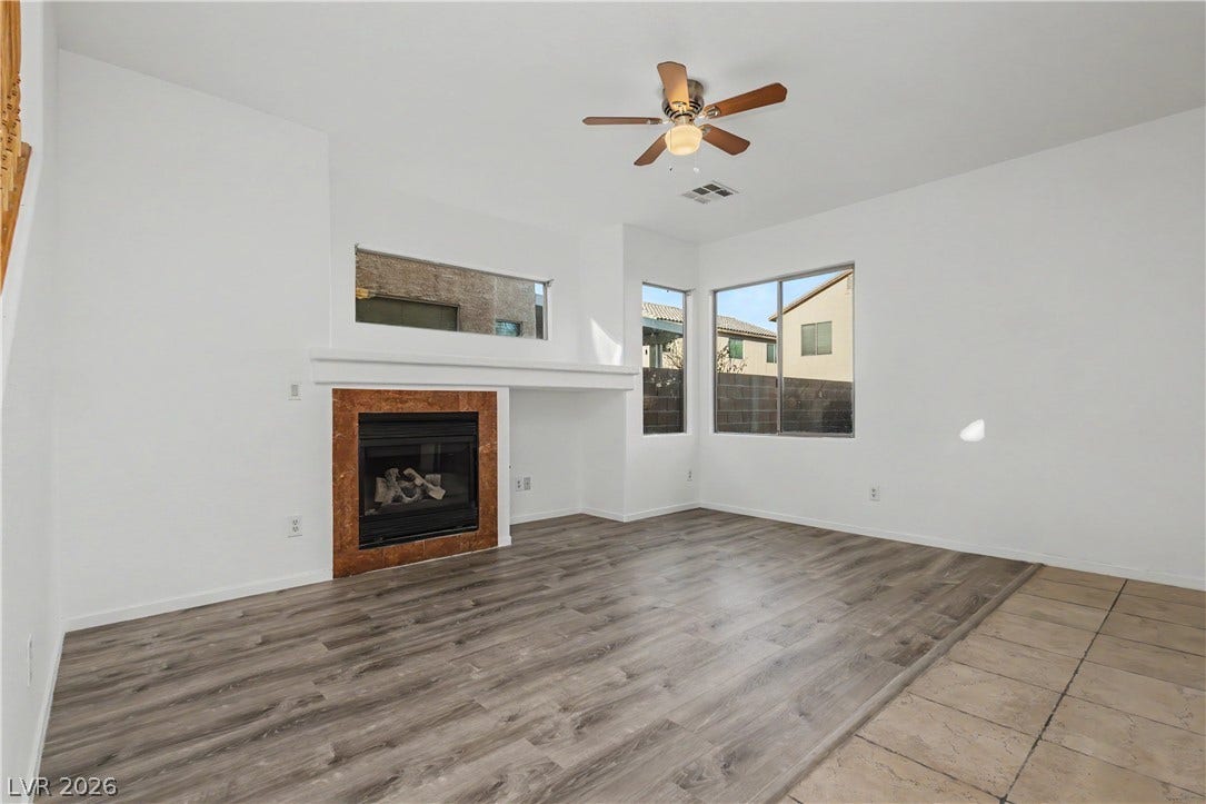 Hardwood floors and a classic tile fireplace anchor this inviting living space.