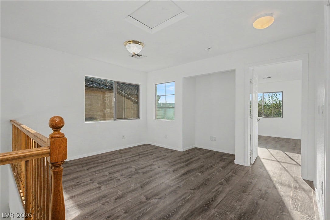 Gleaming wood-look floors anchor this versatile upper-level landing.