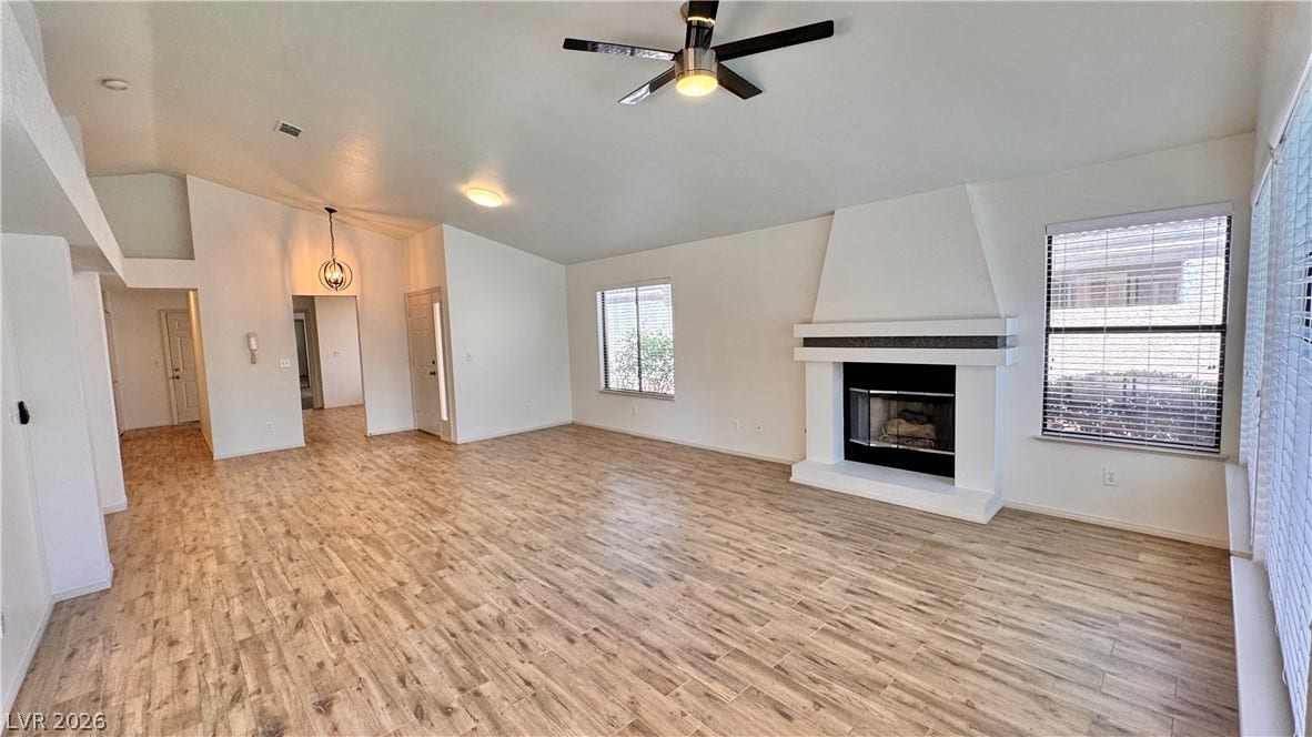 5236 Crooked River Circle, Las Vegas, NV 89149 An inviting fireplace anchor this living space finished with durable wood-look flooring throughout.