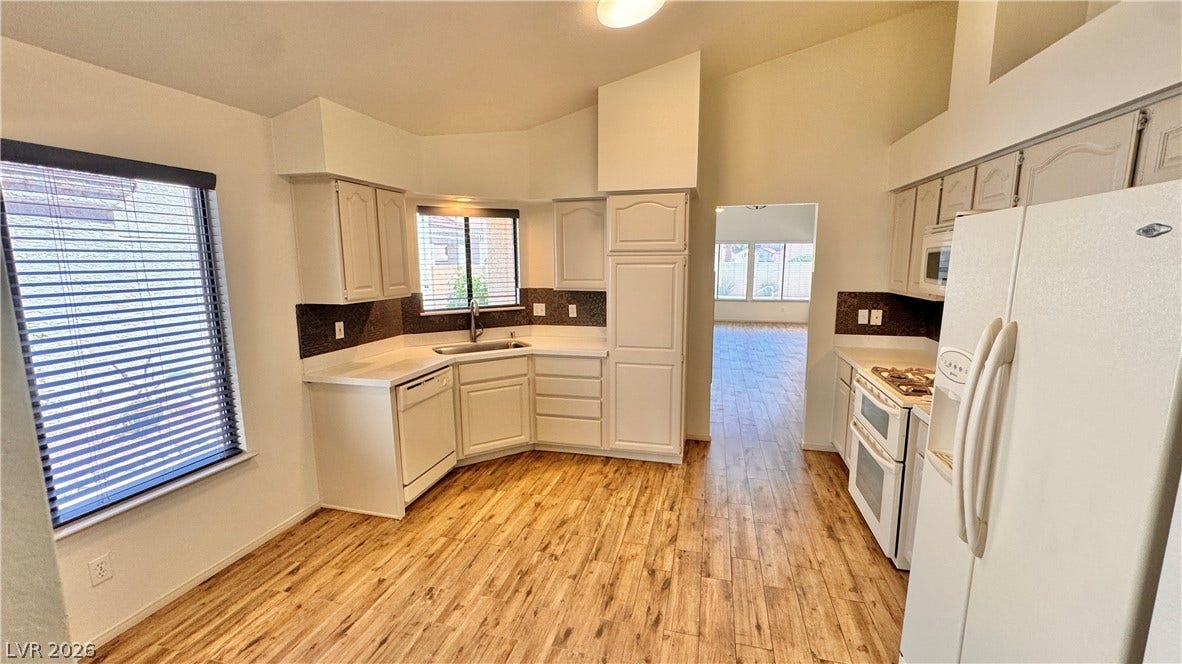 5236 Crooked River Circle, Las Vegas, NV 89149 Vaulted ceilings and warm wood-look flooring enhance this inviting culinary space.