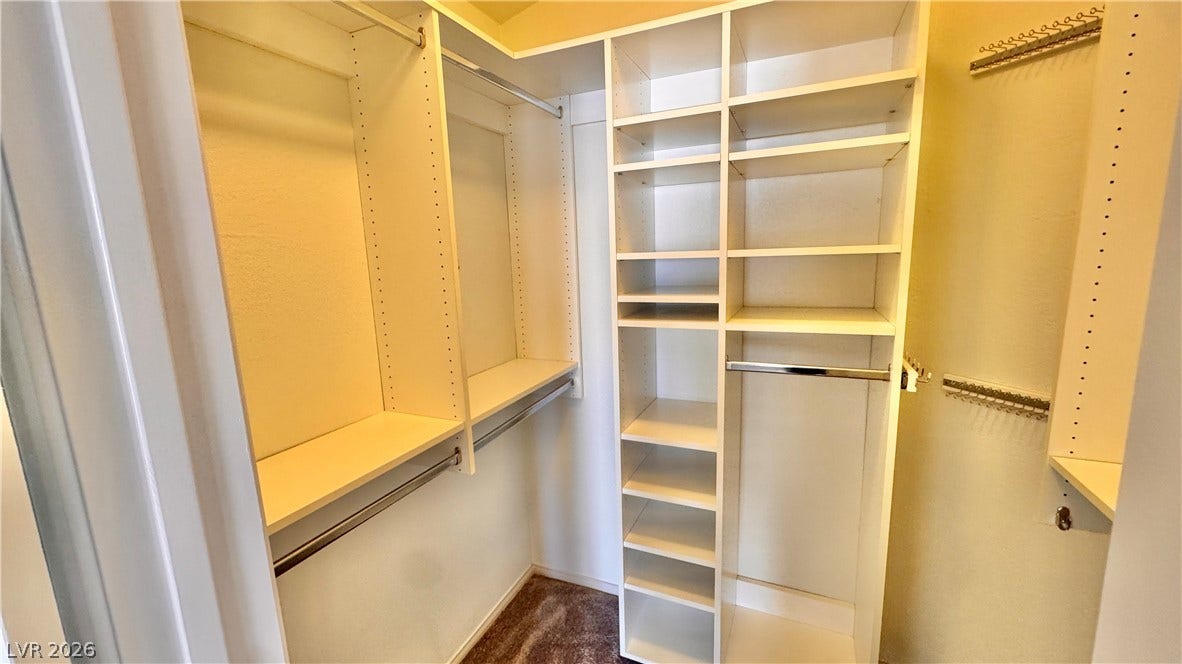 5236 Crooked River Circle, Las Vegas, NV 89149 Custom built-in shelving and hanging rods maximize organization in this functional closet.