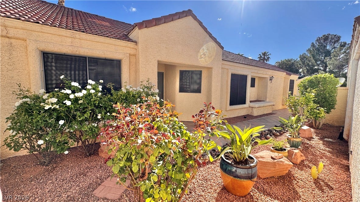 5236 Crooked River Circle, Las Vegas, NV 89149 Mediterranean-inspired architecture highlights this stucco exterior with a classic tile roof and low-maintenance landscaping.