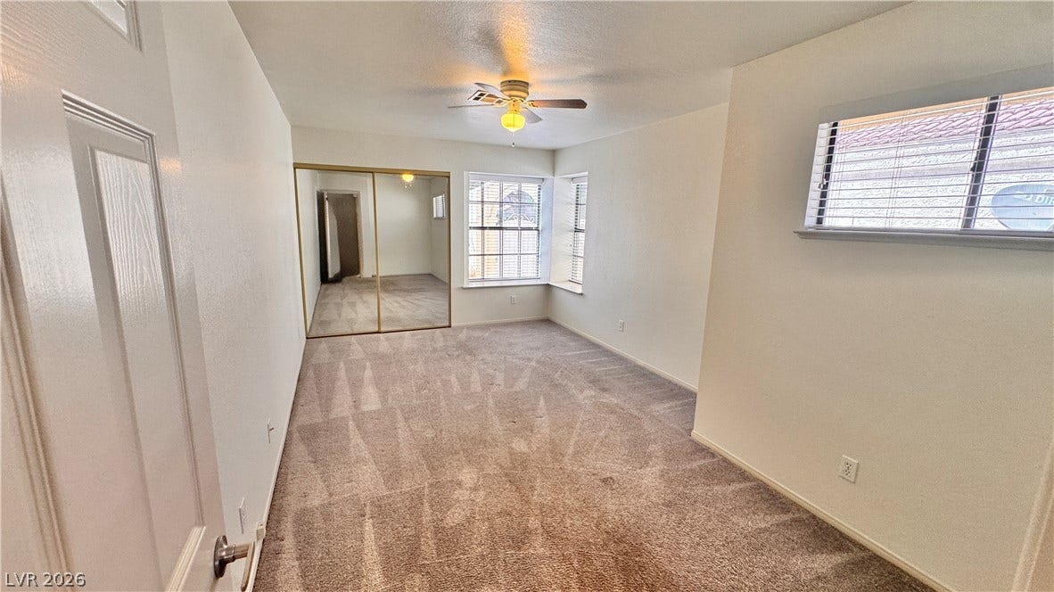 5236 Crooked River Circle, Las Vegas, NV 89149 Plush carpeting and mirrored closet doors define this comfortable bedroom space.