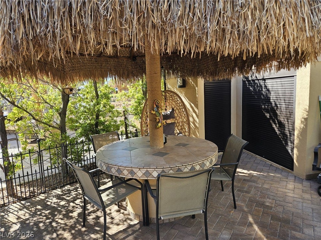 8175 Arville Street, #305, Las Vegas, NV 89139 An inviting patio area boasts durable paver block flooring alongside a decorative wrought iron fence.