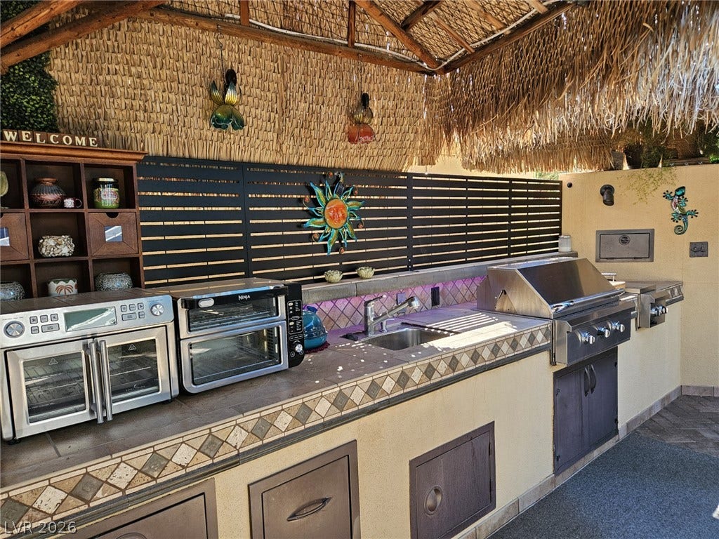 8175 Arville Street, #305, Las Vegas, NV 89139 Sheltered outdoor kitchen provides a fully equipped cooking station with integrated tiling.