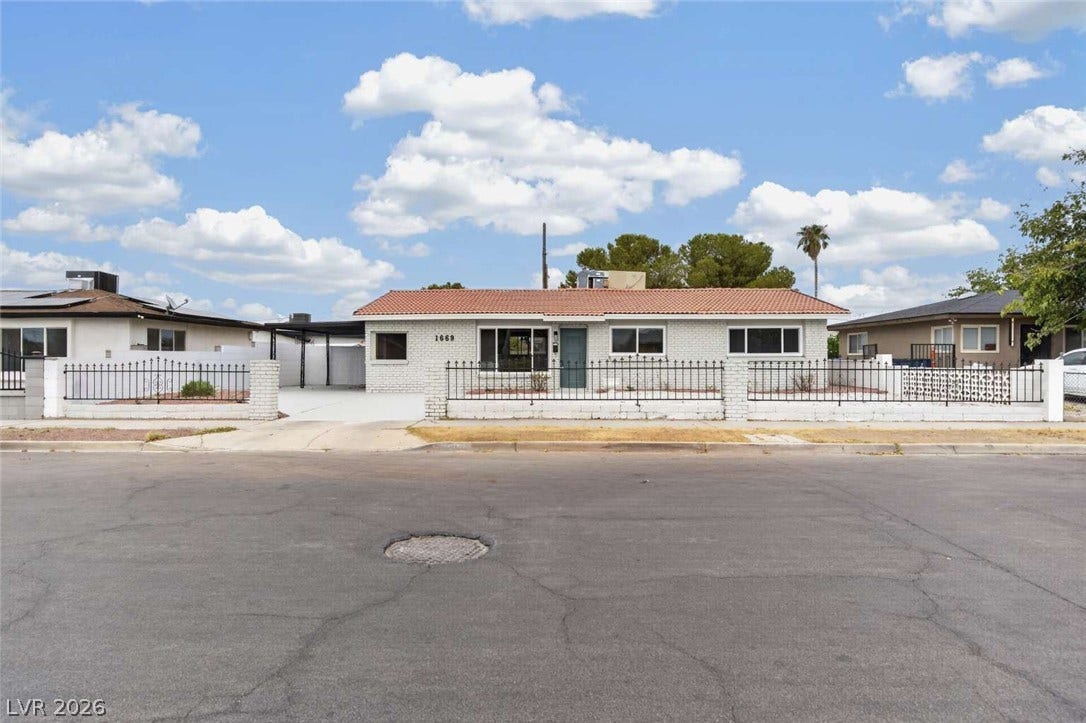 1669 N G Street, Las Vegas, NV 89106 Spanish tile roofing and custom wrought iron fencing enhance the curb appeal of this classic single-story home.