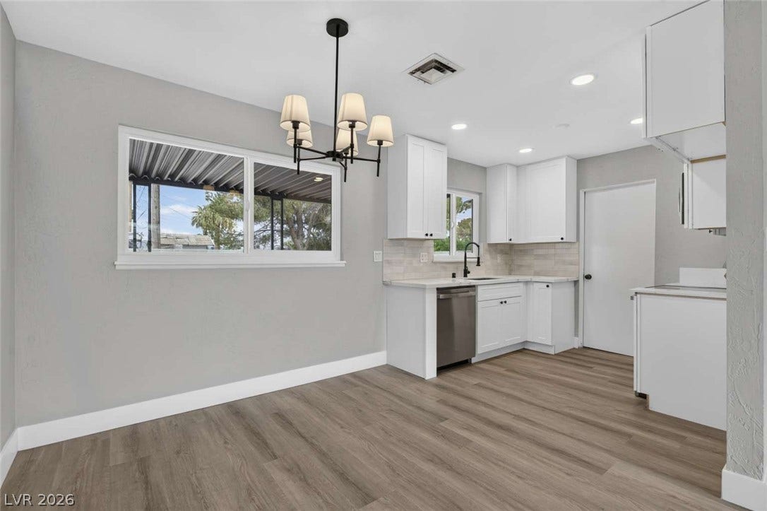 1669 N G Street, Las Vegas, NV 89106 Clean lines and durable plank flooring define this updated open-concept kitchen and dining area.
