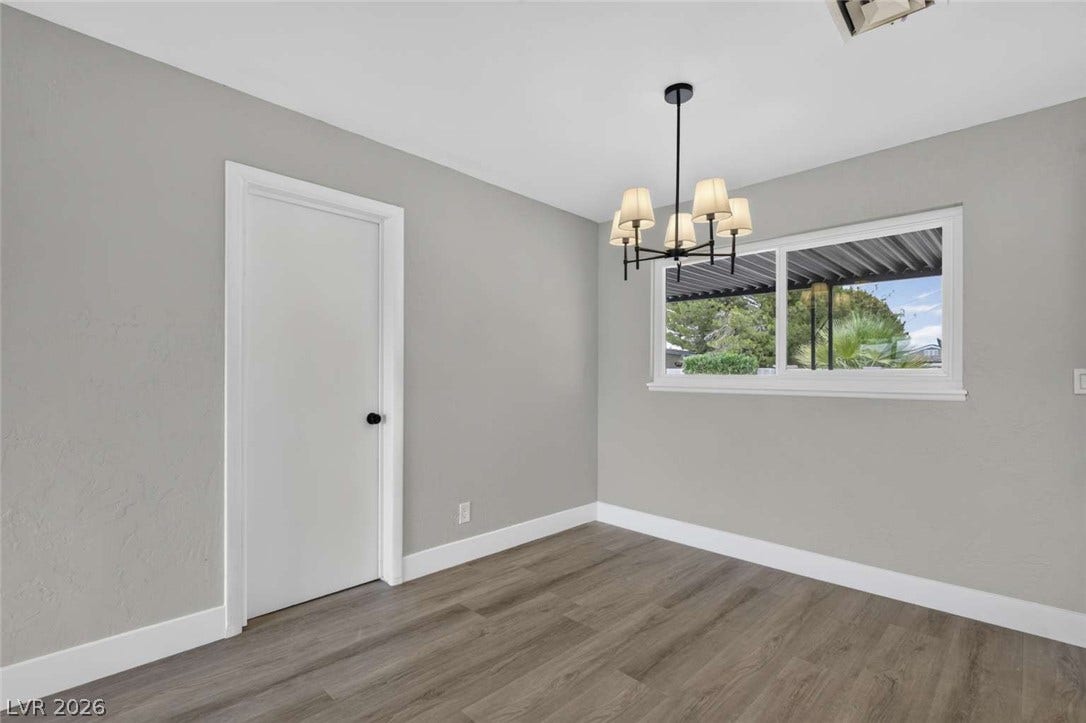1669 N G Street, Las Vegas, NV 89106 Hardwood floors and a classic light fixture define this versatile room.
