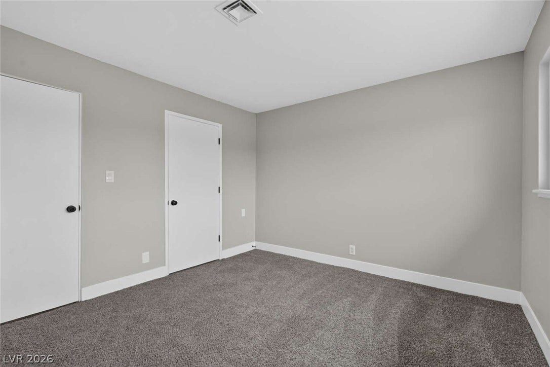 1669 N G Street, Las Vegas, NV 89106 Plush carpeting anchors this versatile room featuring clean walls and crisp white trim.