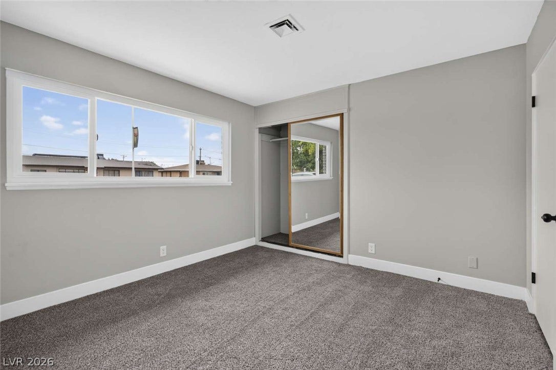 1669 N G Street, Las Vegas, NV 89106 Plush carpeting and a mirrored sliding closet door complete this comfortable bedroom space.
