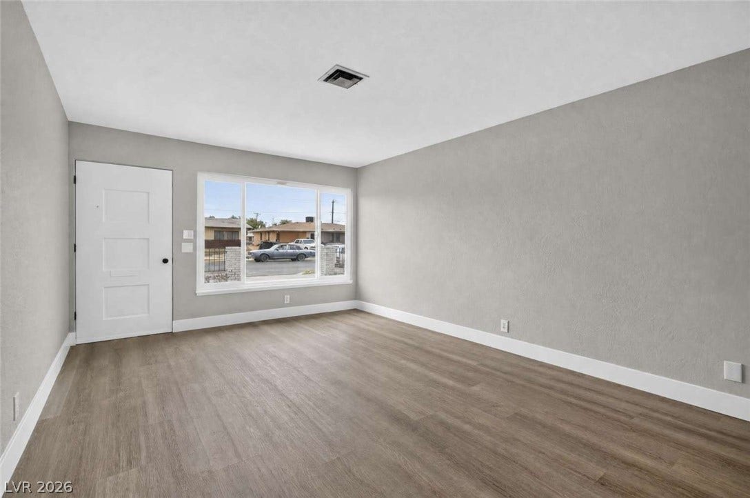 1669 N G Street, Las Vegas, NV 89106 Smooth wood-style flooring and a large front window define this welcoming entryway space.