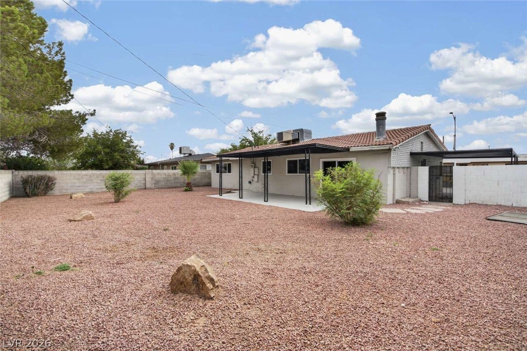 1669 N G Street, Las Vegas, NV 89106 A spacious gravel yard features a covered patio area perfect for outdoor relaxation.