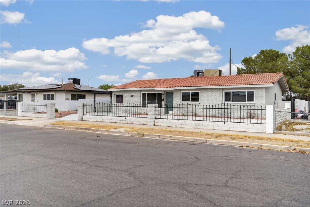 1669 N G Street, Las Vegas, NV 89106 Spanish tile roofing and classic brick construction define this single-story neighborhood home.
