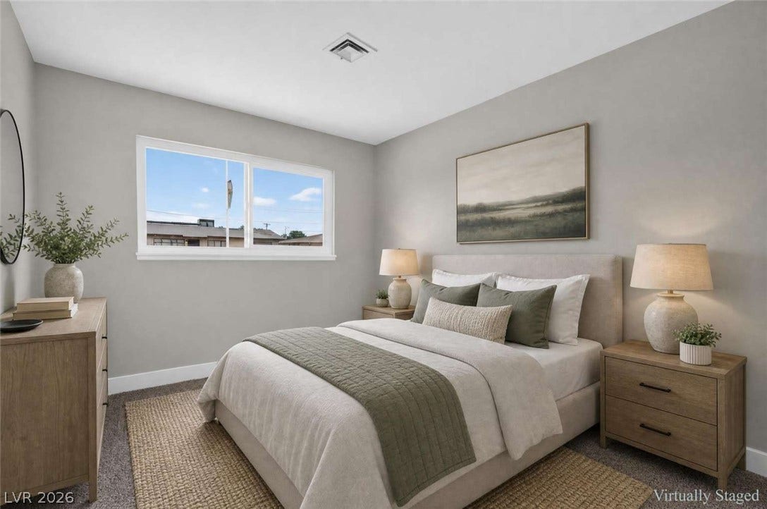 1669 N G Street, Las Vegas, NV 89106 A wide window illuminates this bedroom featuring plush carpeting and clean plaster walls.