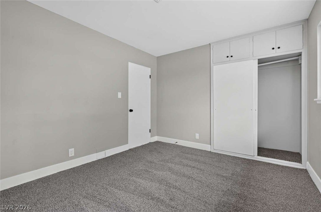 1669 N G Street, Las Vegas, NV 89106 Smooth plaster walls and soft carpeting define this comfortable bedroom space.
