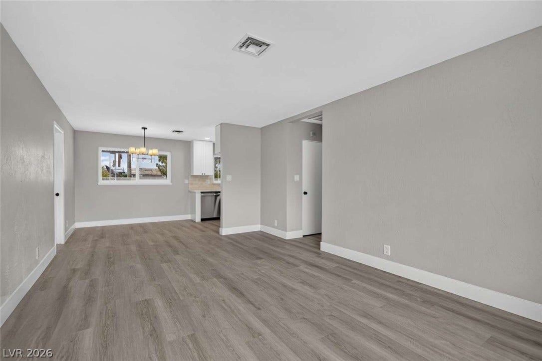 1669 N G Street, Las Vegas, NV 89106 Smooth wood-look flooring and clean lines connect the open dining area to the kitchen.