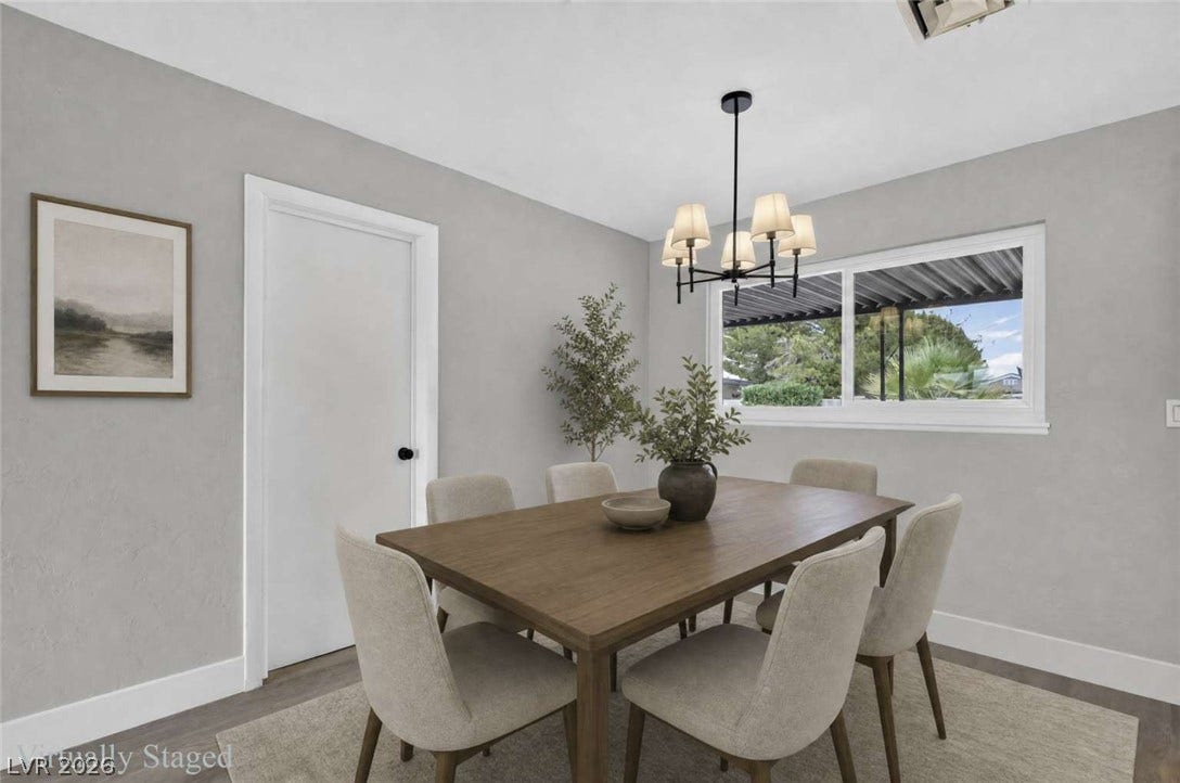 1669 N G Street, Las Vegas, NV 89106 A window frames tree-filled views in this inviting dining area finished with wood flooring.