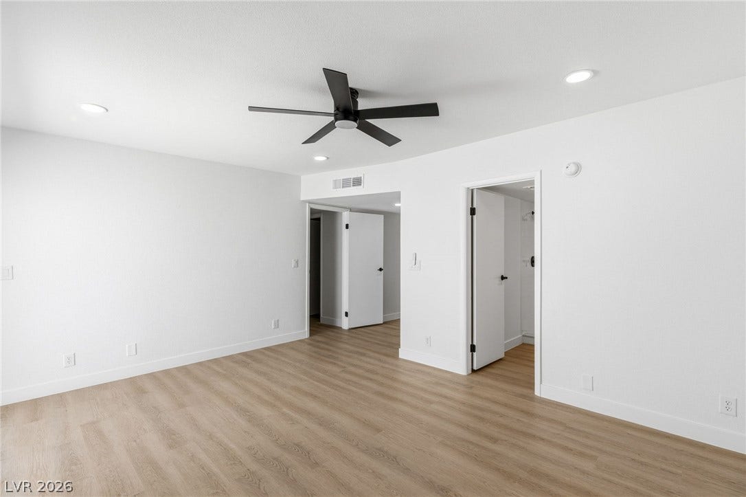 3471 One Nation Avenue, Las Vegas, NV 89121 Recessed lighting illuminates this room with new light wood flooring and a modern ceiling fan.