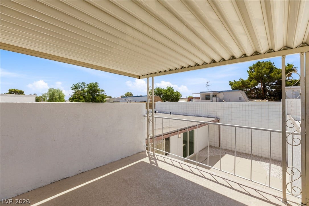 3471 One Nation Avenue, Las Vegas, NV 89121 A well-covered deck offers a private outdoor retreat with a serene neighborhood view.