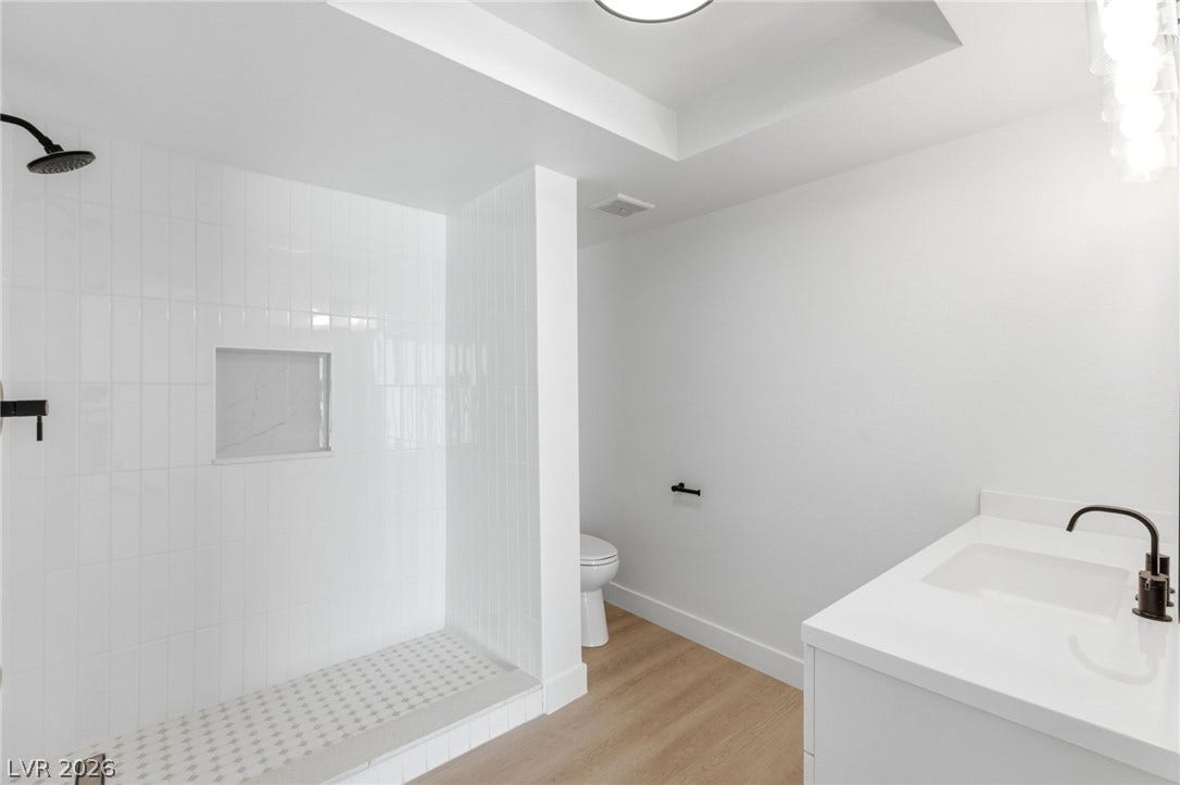 3471 One Nation Avenue, Las Vegas, NV 89121 A pristine bath offers a spacious walk-in shower and a sleek vanity for a refreshing daily routine.