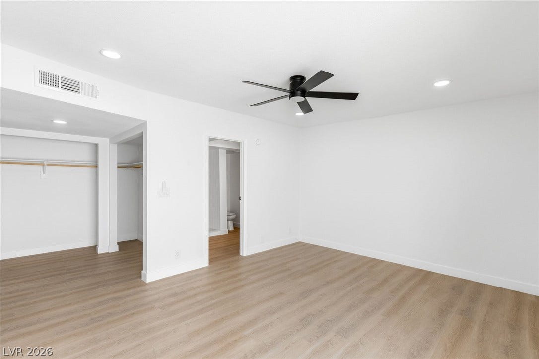 3471 One Nation Avenue, Las Vegas, NV 89121 Bright and airy, this bedroom features natural wood-look flooring and a modern ceiling fan for comfort.