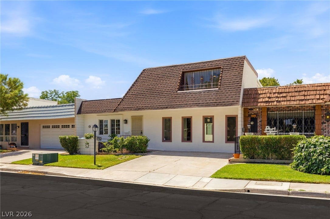 3471 One Nation Avenue, Las Vegas, NV 89121 A classic front facade boasts a prominent dormer window and well-maintained shrubbery for curb appeal.
