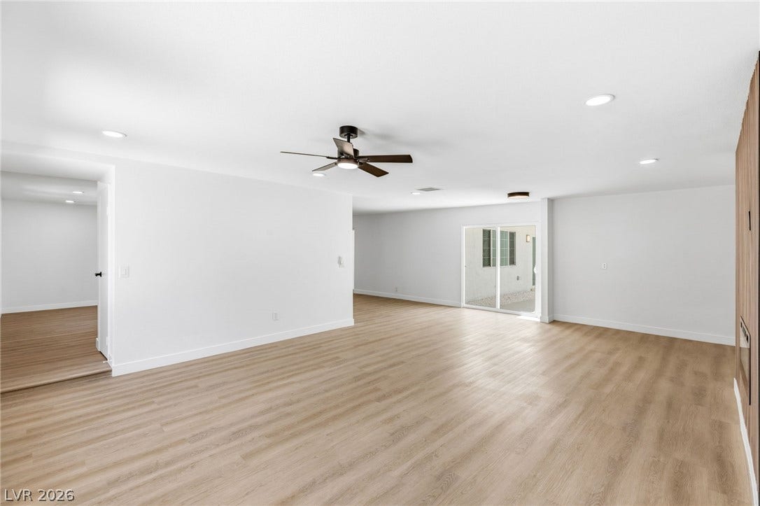 3471 One Nation Avenue, Las Vegas, NV 89121 An open concept living space with light wood-style flooring and modern lighting, ideal for entertaining.