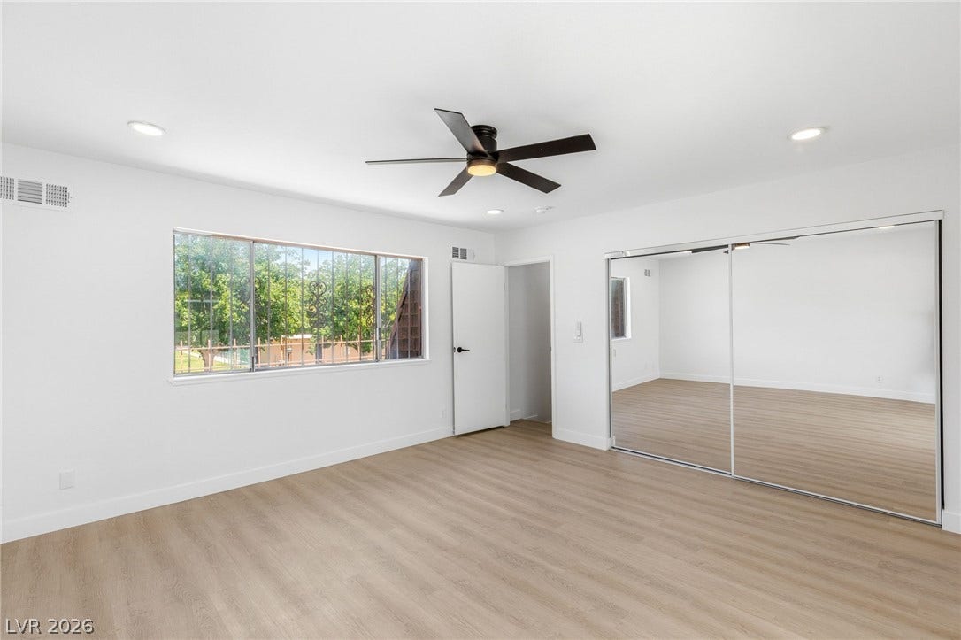 3471 One Nation Avenue, Las Vegas, NV 89121 A naturally illuminated bedroom offers hardwood floors and a spacious mirrored closet.