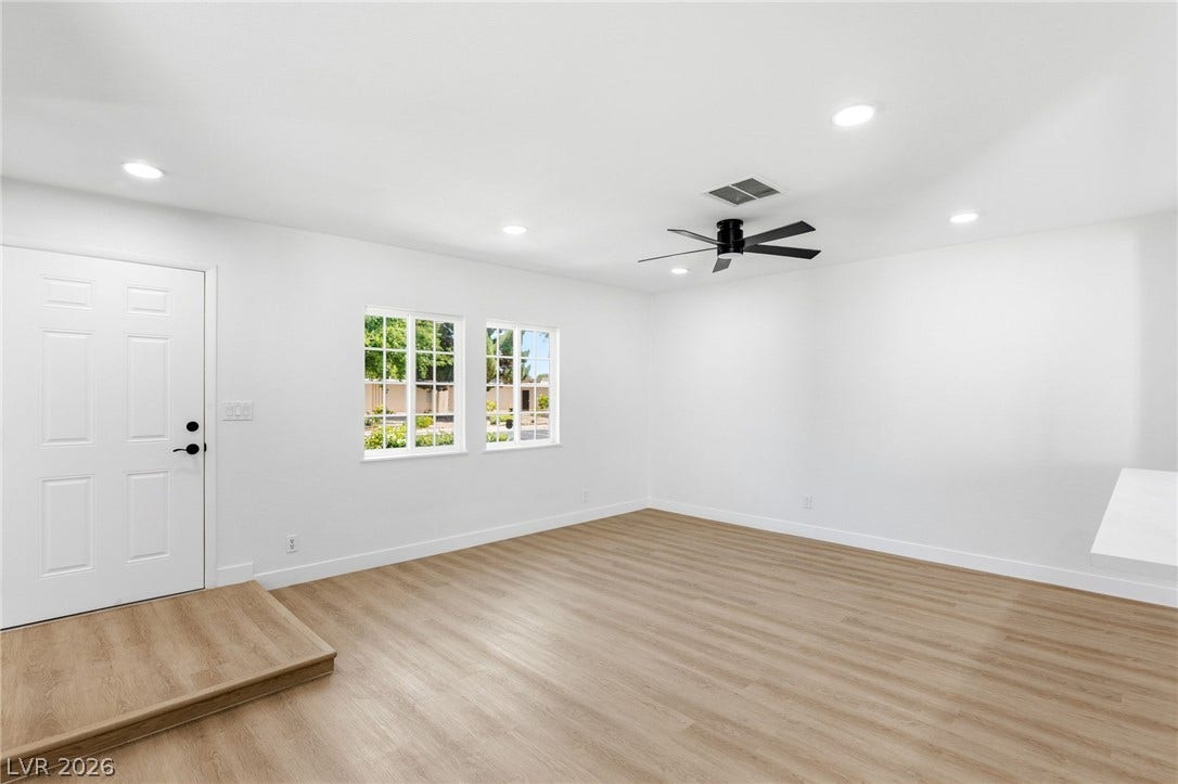 3471 One Nation Avenue, Las Vegas, NV 89121 A welcoming entry, with a classic paneled door and light wood-look flooring, leads into a bright room.