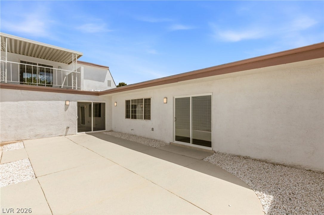 3471 One Nation Avenue, Las Vegas, NV 89121 A spacious concrete patio awaits outdoor living, complemented by the upper-level balcony.