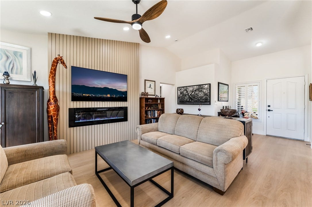 An inviting entry leads directly into a relaxed living space featuring modern light wood flooring.