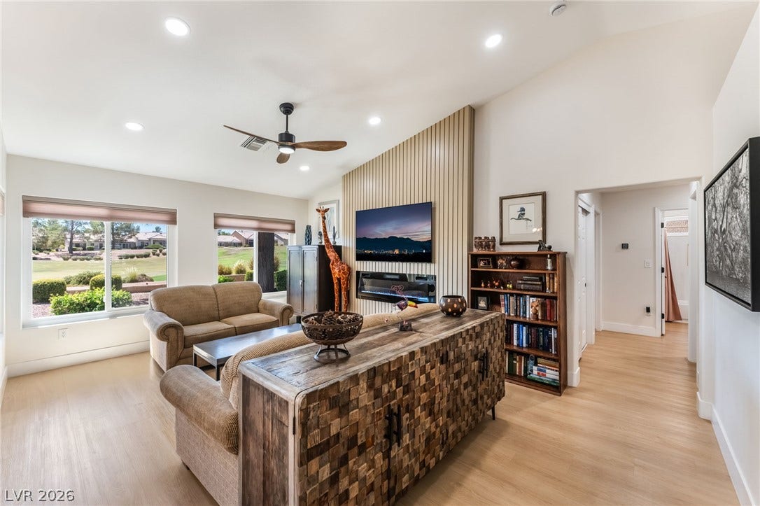 Vaulted ceilings and warm wood floors define this inviting main living area with backyard views.