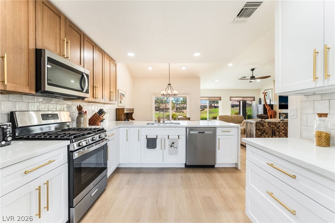 An open floorplan connects the modern kitchen directly to the main living areas.