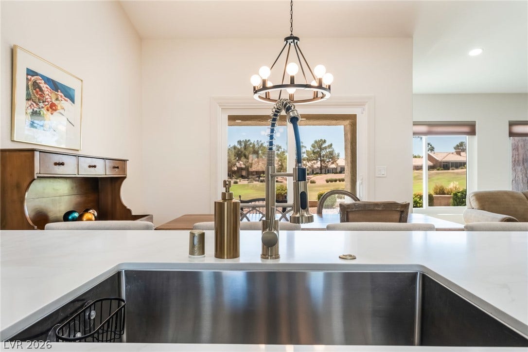 An open floorplan design allows effortless connection from the kitchen sink to neighboring spaces.