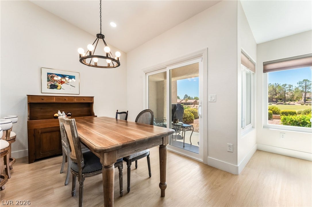 Sliding glass doors open directly to the outdoors, bathing the wood-floored dining space in natural light.