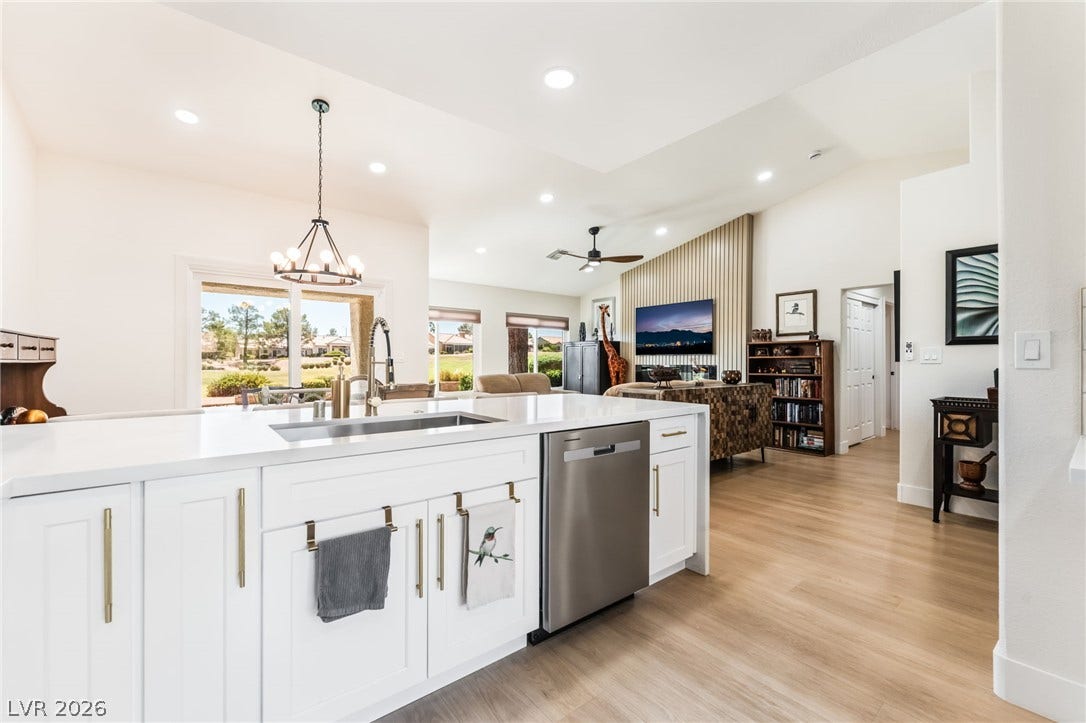 An open floorplan seamlessly connects the modern kitchen and airy living spaces.